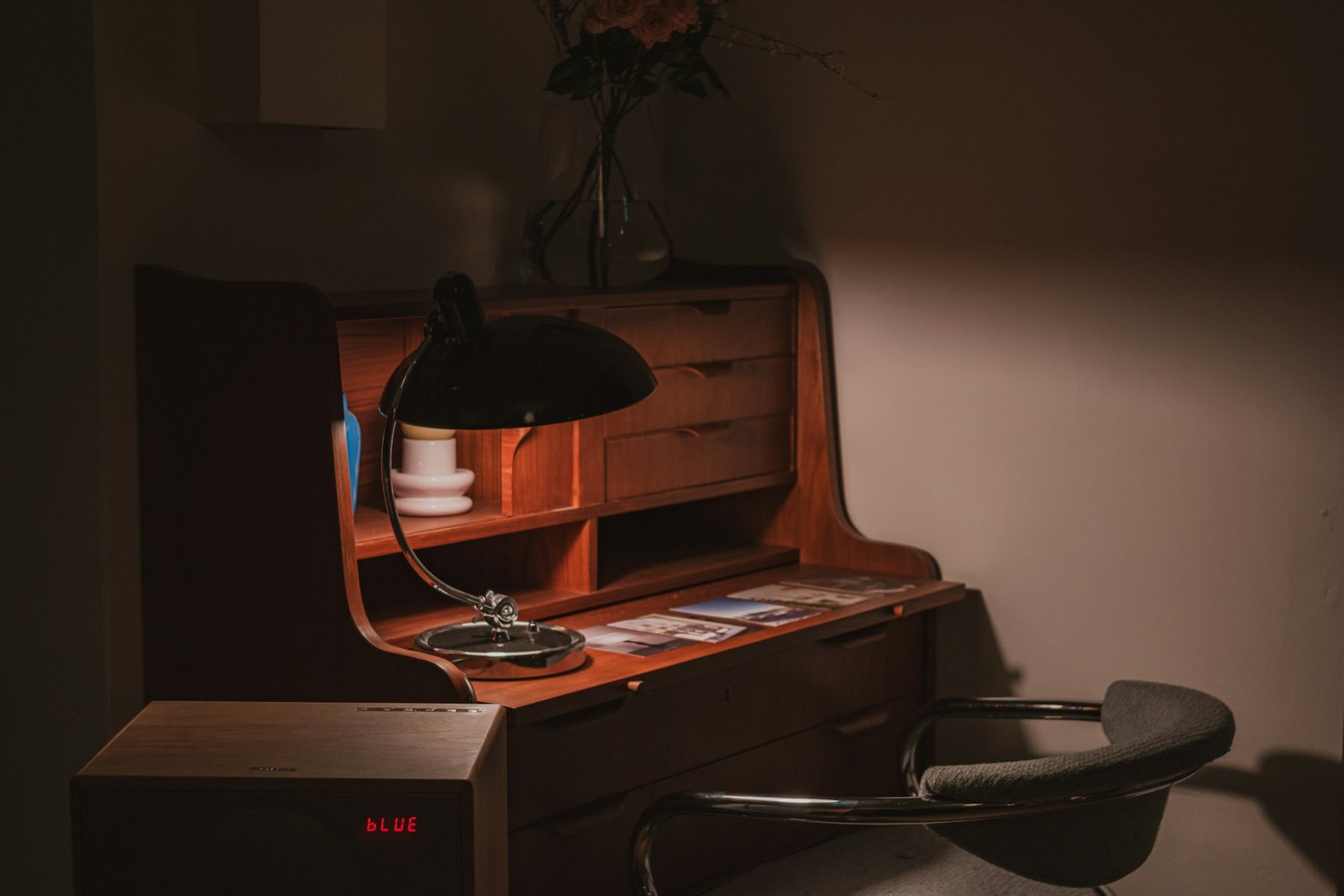 A vintage writing desk lit warmly by a lamp — the considered space of practice.